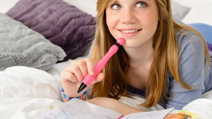 teen girl smiling looking into the sky, on her bed