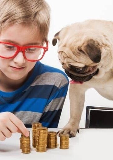 boy kid in red glasses counting money he's saving for short term kid goal