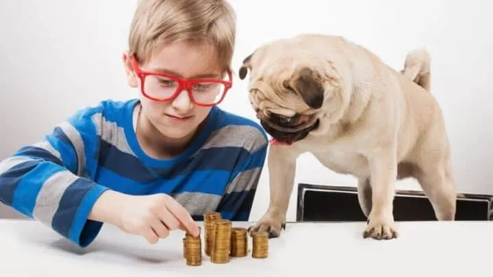 boy kid in red glasses counting money he's saving for short term kid goal