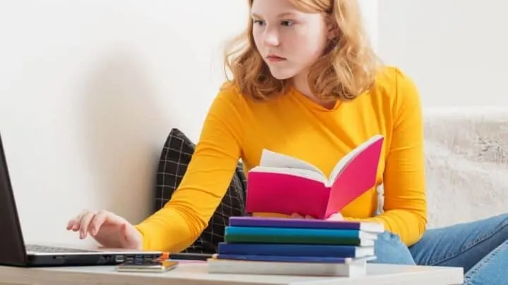 high school student girl with orange shirt reading red business book
