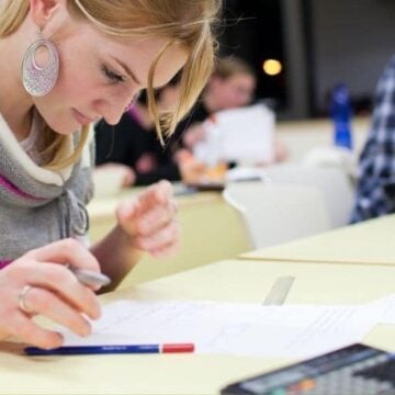 girl student with pretty earring working on financial literacy pdf worksheet