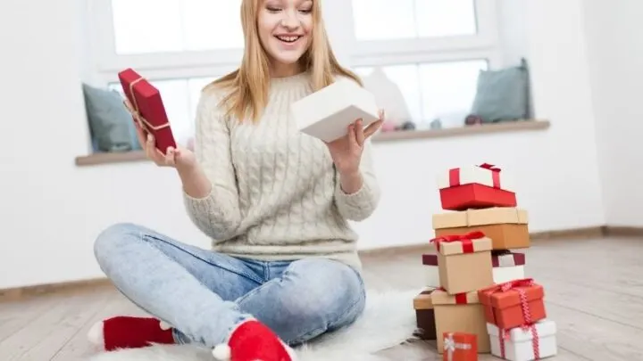 teen girl opening up Christmas eve box for teen