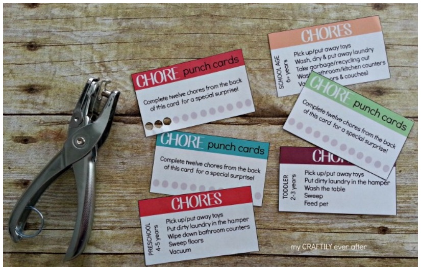 set of chore punch cards with hole puncher on wooden background