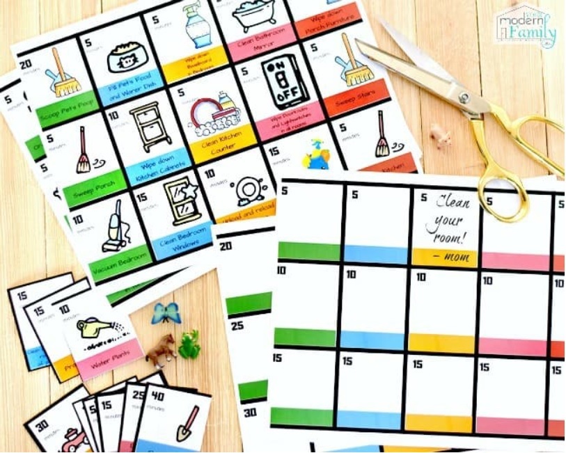 chore chart visuals green, blue, yellow, pink, and red picture chore card set on wooden table