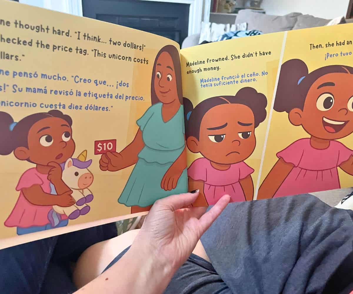 blogger reading Madeline's Money Adventure to son on couch