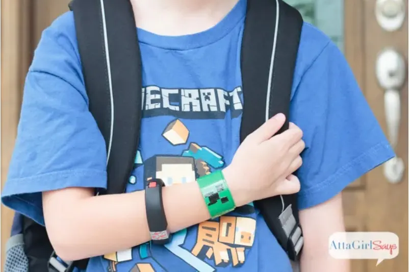 boy in blue minecraft shirt with green creeper slap bracelet on