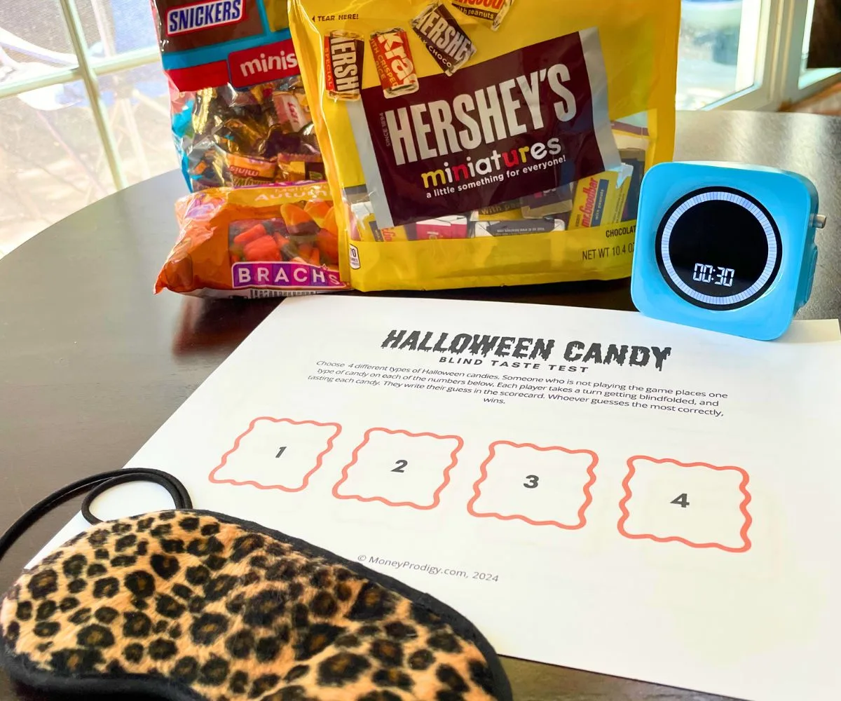 Halloween Candy Blind Taste Test printable with candy bags, blue timer, and blindfold
