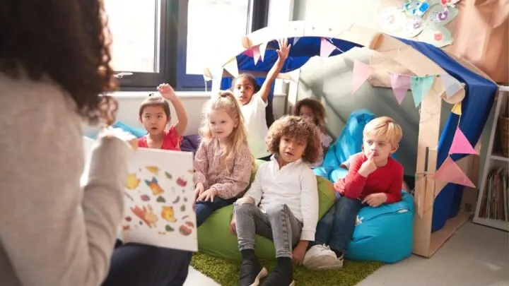 teacher reading a money book for kindergarten students