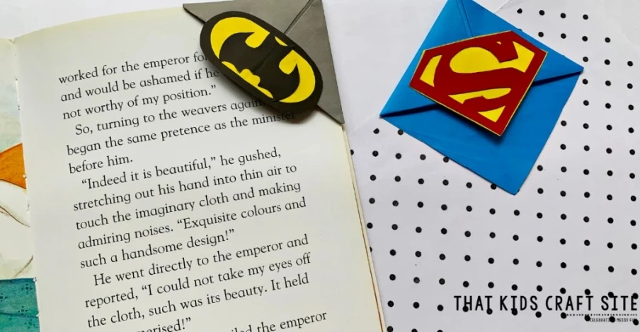 superman and batman logo origami bookmarks that sit on corner of a book page