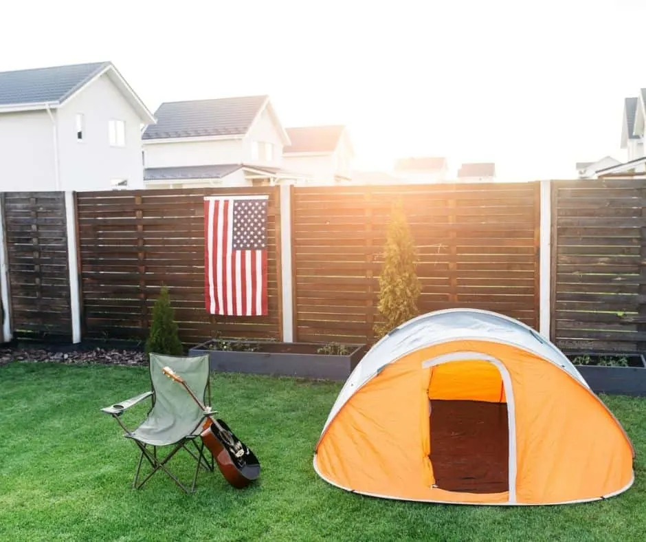 yellow tent pitched in backyard as a sleepover teen activity