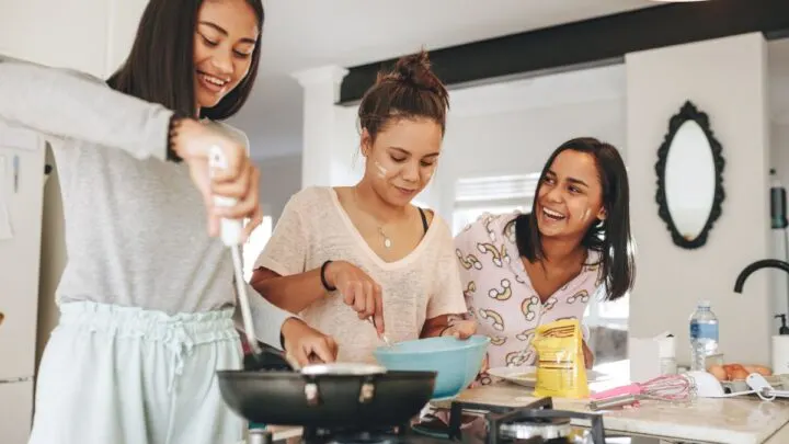 three teen girls making thanksgiving day breakfast for parents