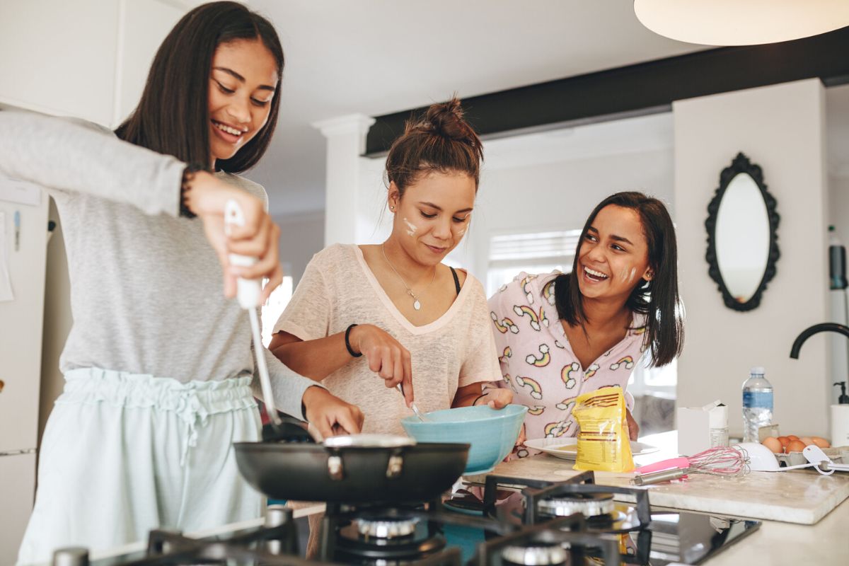 three teen girls making thanksgiving day breakfast for parents