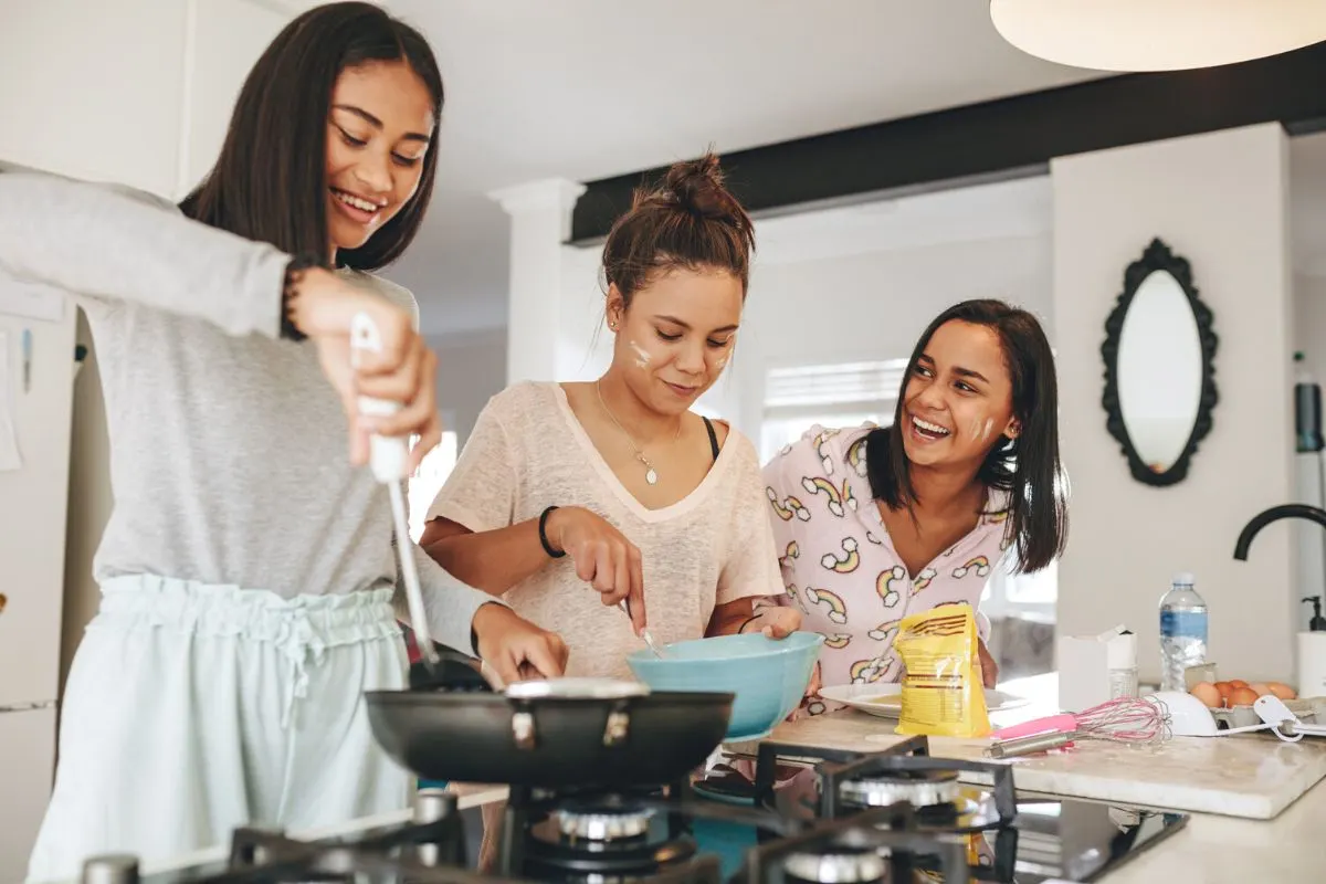 three teen girls making thanksgiving day breakfast for parents