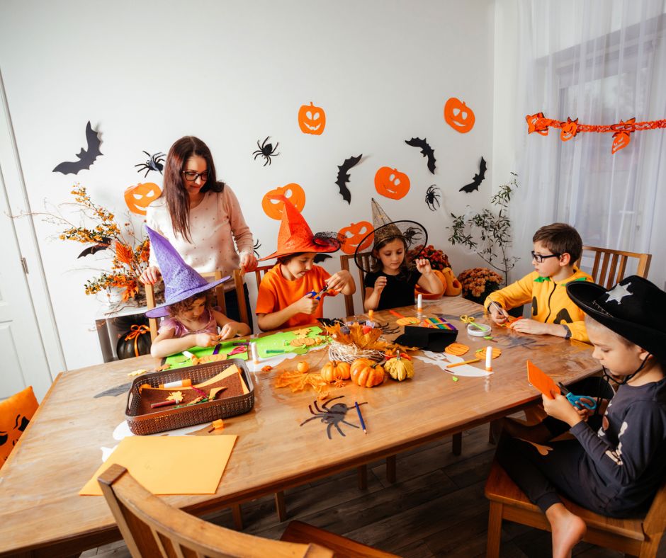 Mother with kids around kitchen table, listening to Halloween podcast episodes, lots of decorations on wall