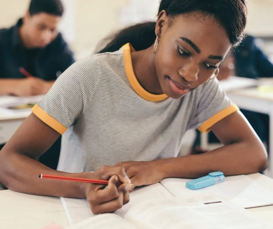 teen high school student girl working on Black Friday essay