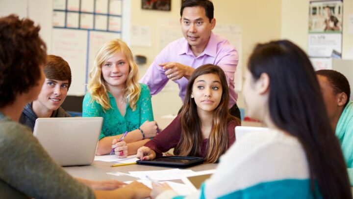 classroom group of teens with teacher discussing money topics