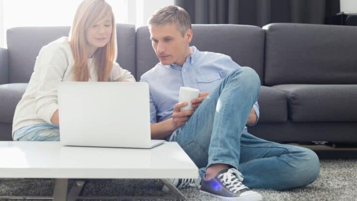 teen girl with father looking at white laptop, paypal account