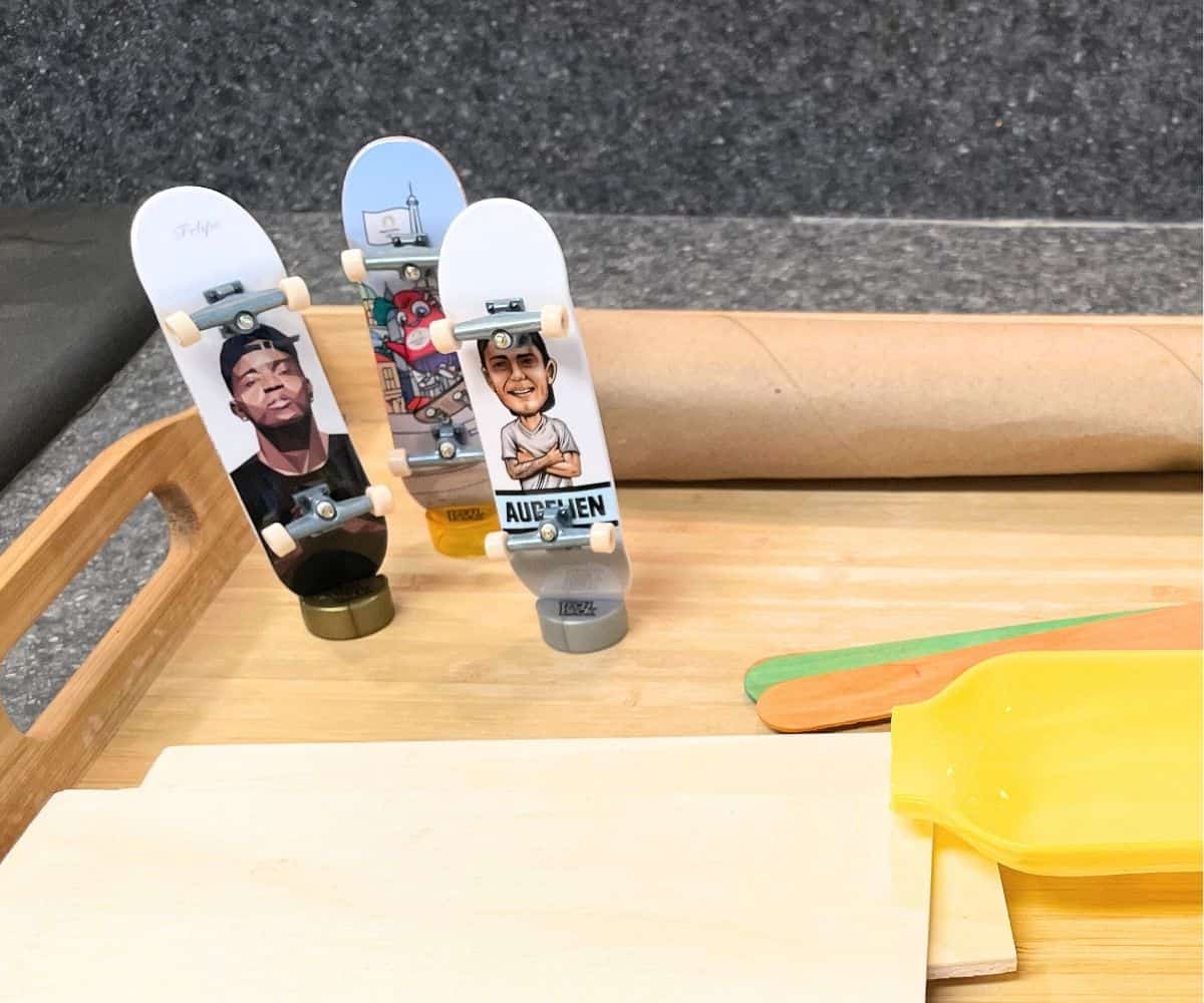 three fingerboards standing up on little stands