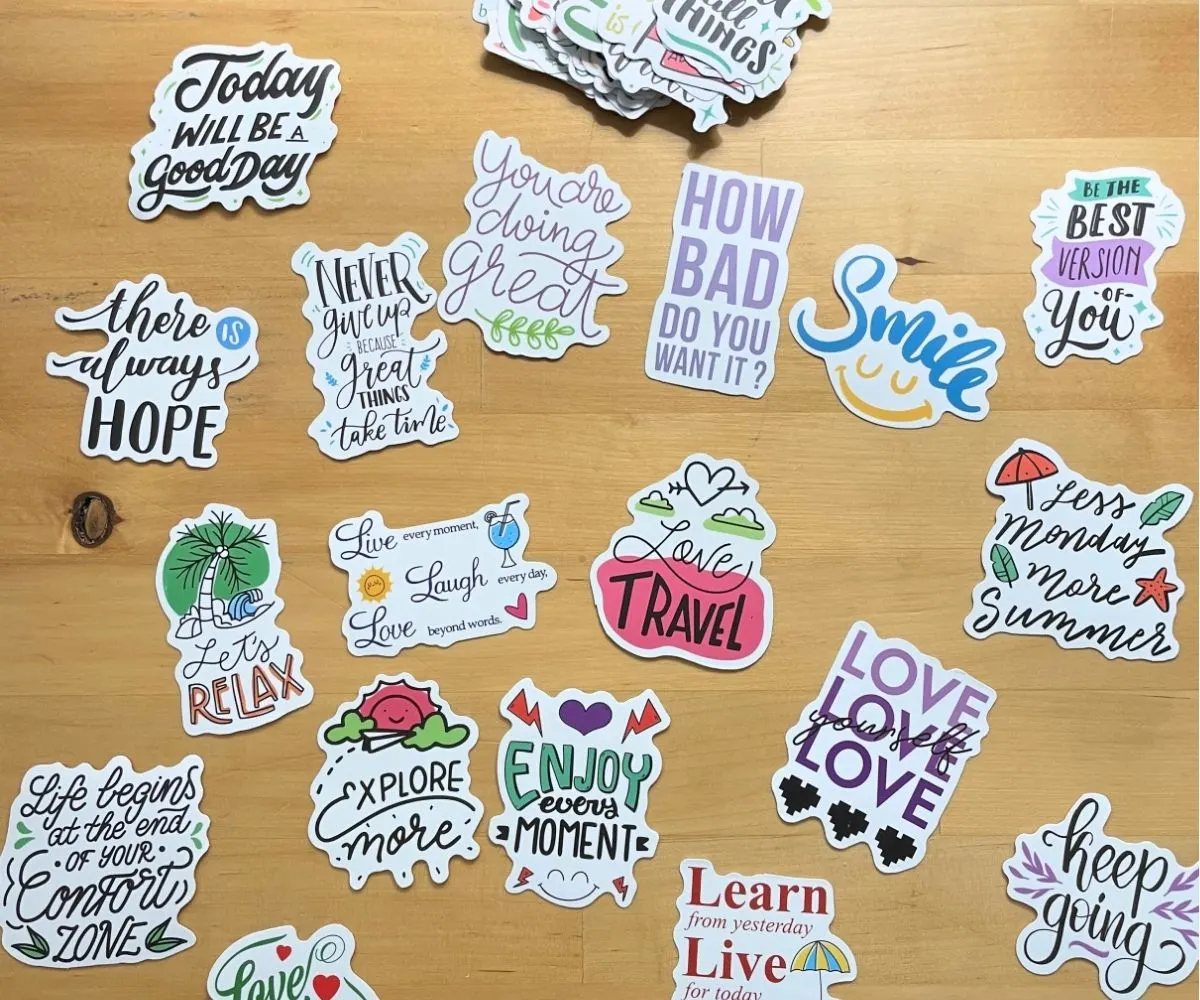 a bunch of teen friendly and fun vinyl stickers on a wooden table