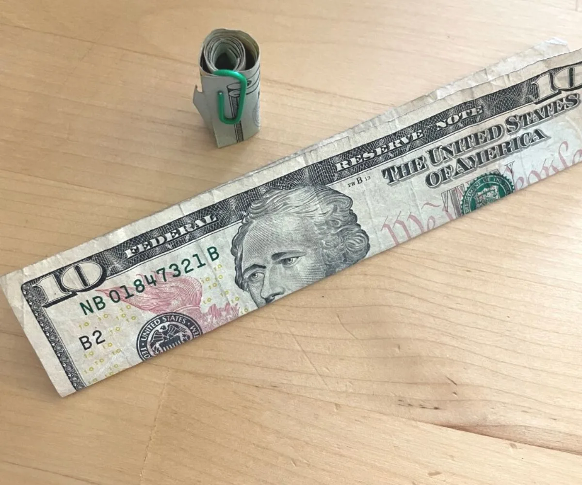 $10 bill folded in half lengthwise