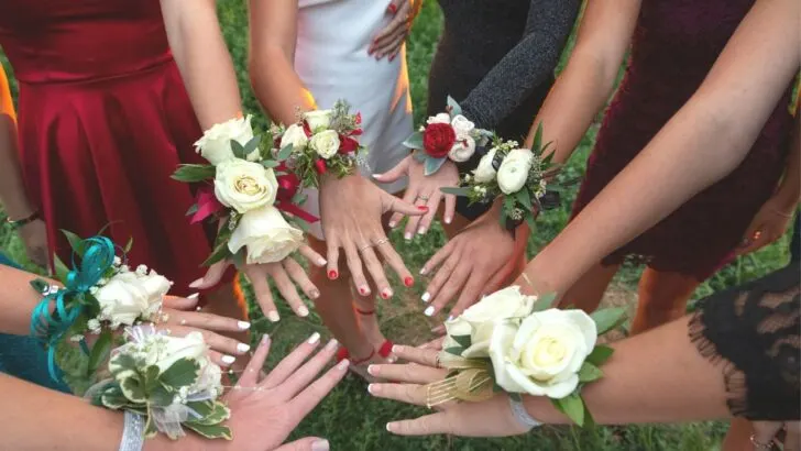 group of girls' manicured hands with corsages ready for prom