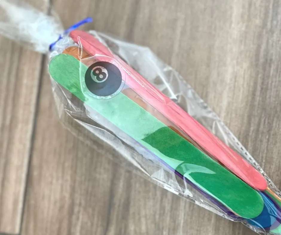 plastic cone shaped bag with colorful tie with figure out sticker and colorful popsicle sticks inside