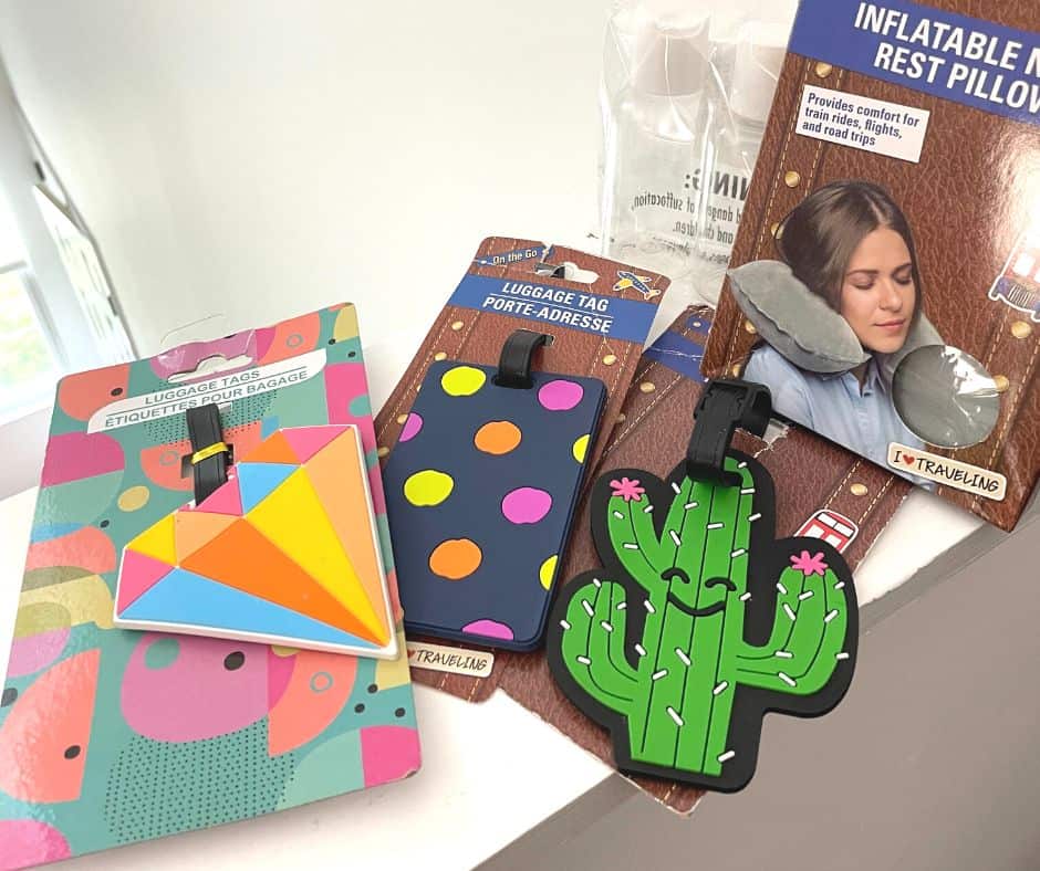 cactus, diamond, and colorful luggage tags with TSA bottles and inflatable pillow