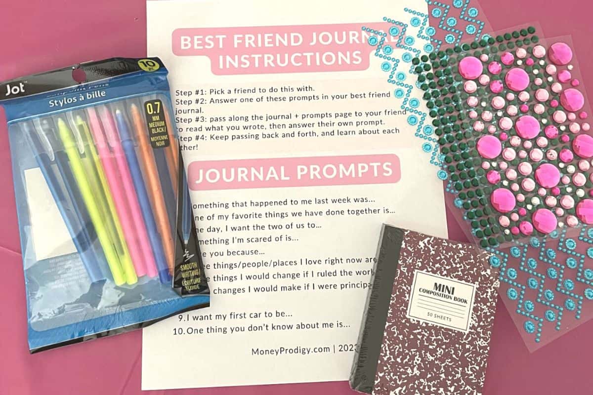 journal, gem stickers, pens, best friend journal prompts on pink table at market day