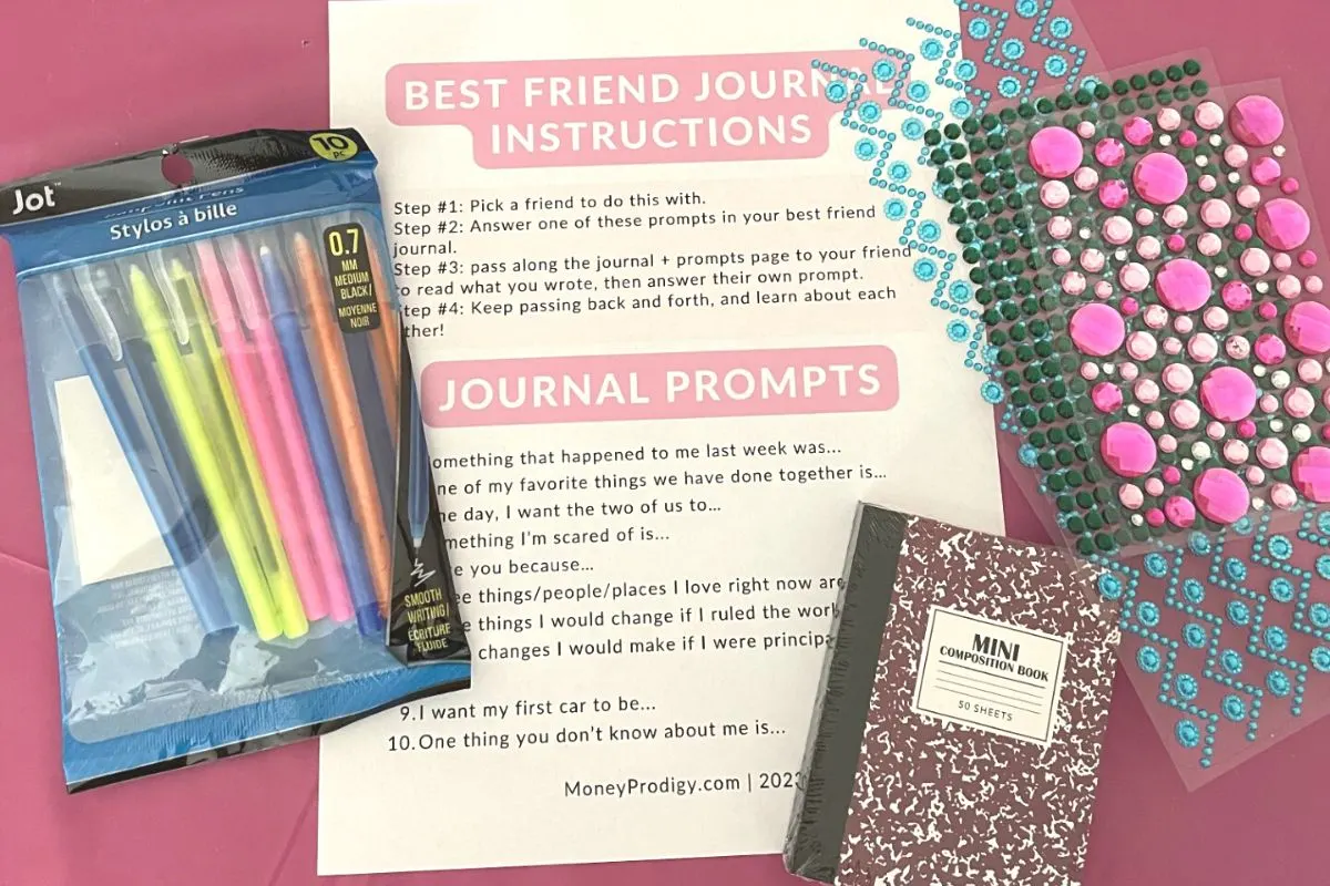 journal, gem stickers, pens, best friend journal prompts on pink table at market day