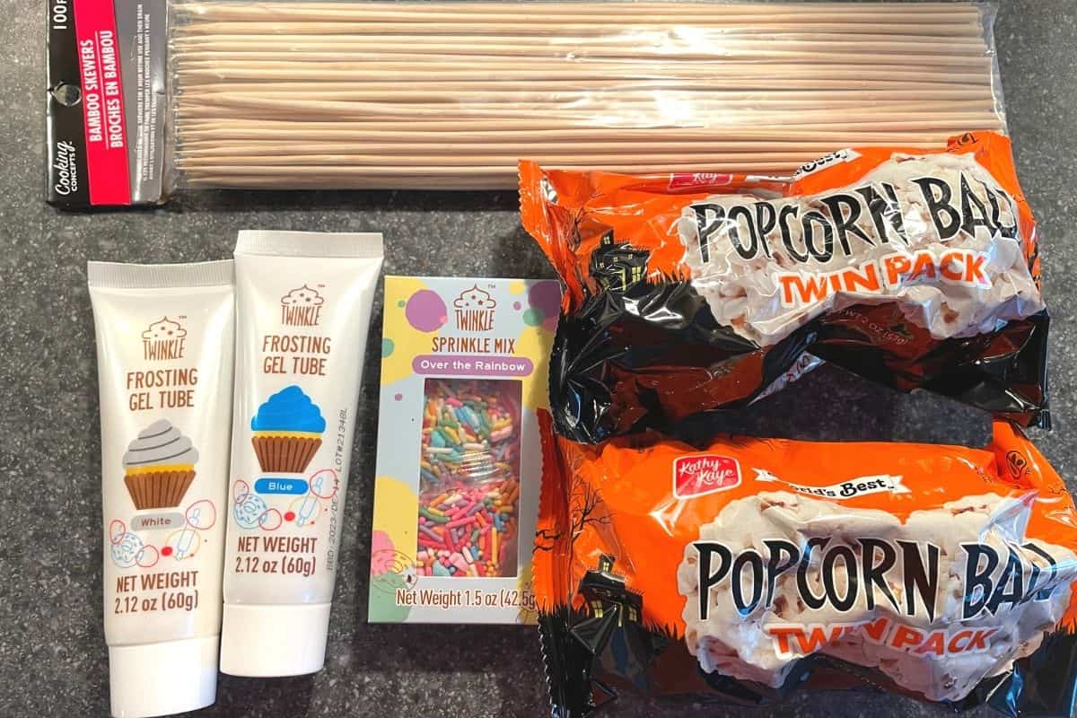 two bags of popcorn balls, bamboo skewers, and different frosting tubes from Dollar Tree