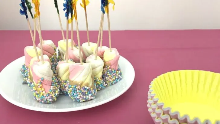 sprinkled covered rainbow marshmallows and cupcake liners on market day table to sell