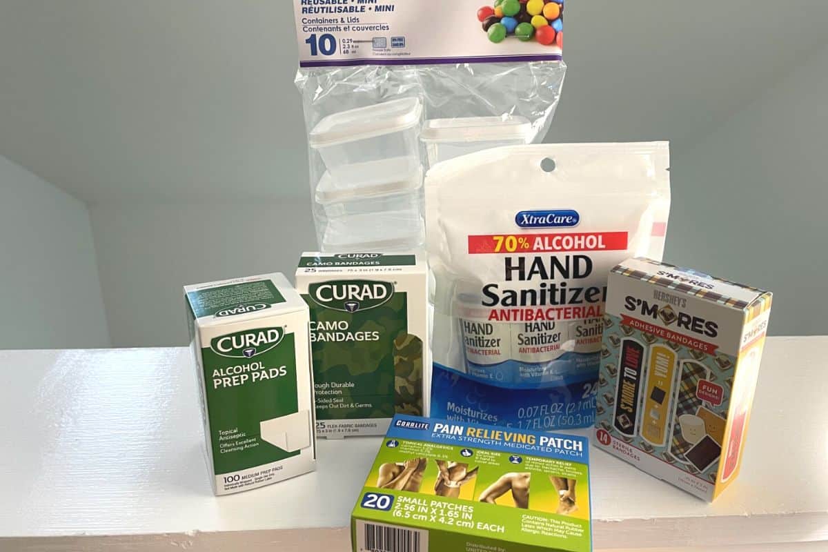 group of first aid products from Dollar Tree like bandaids, hand sanitizer packages, etc.