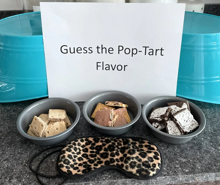 teal buckets turned over, three pop-tart flavors in three bowls and sign that says