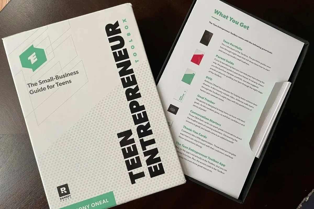 Teen Entrepreneur Toolbox opened on dark table with table of contents sheet