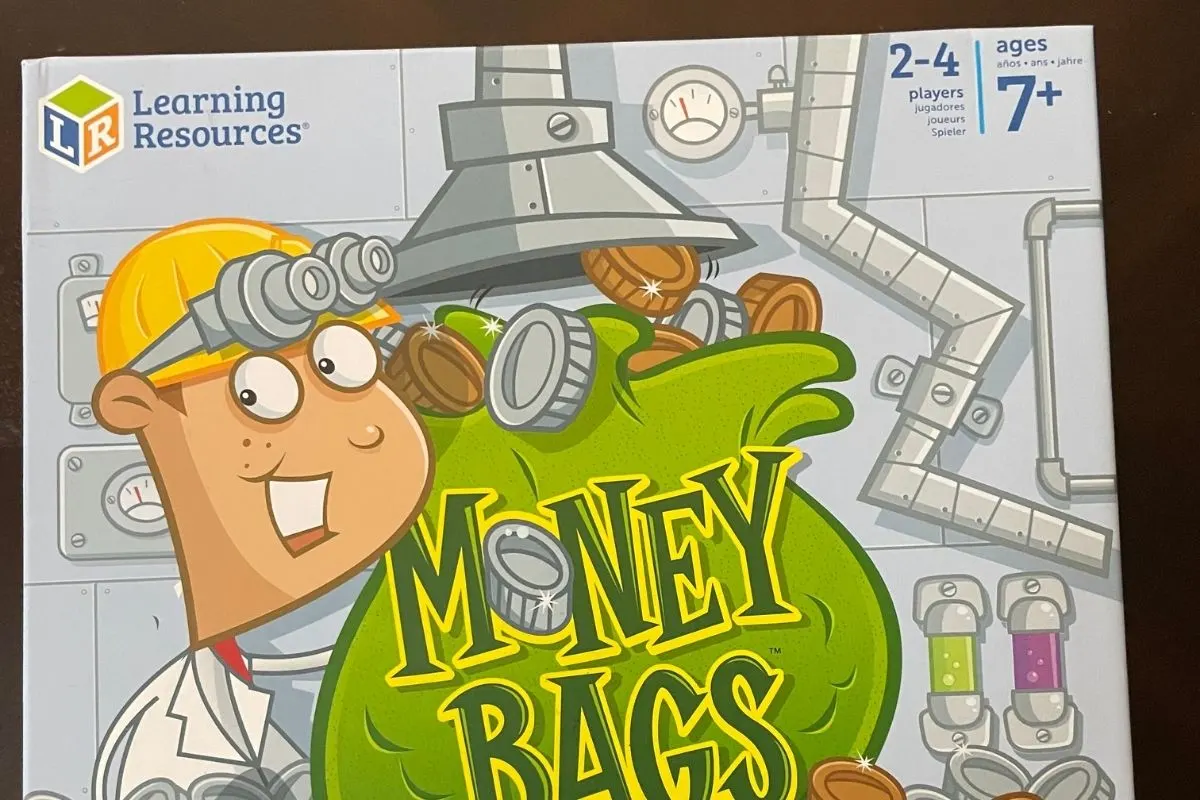 money bags light gray board game cover with cartoon person and money bag of coins on it