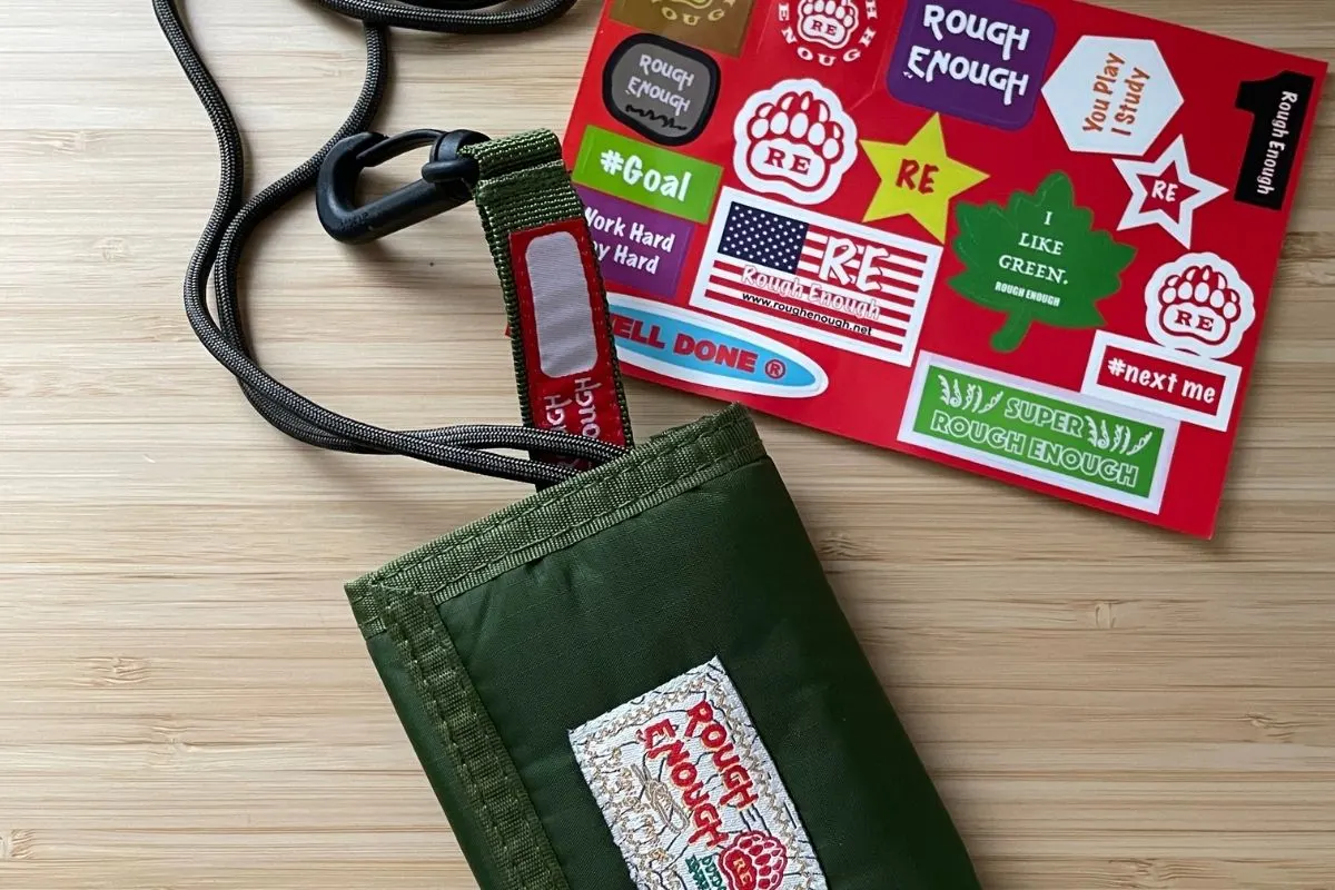 military green wallet with lanyard and sheet of stickers