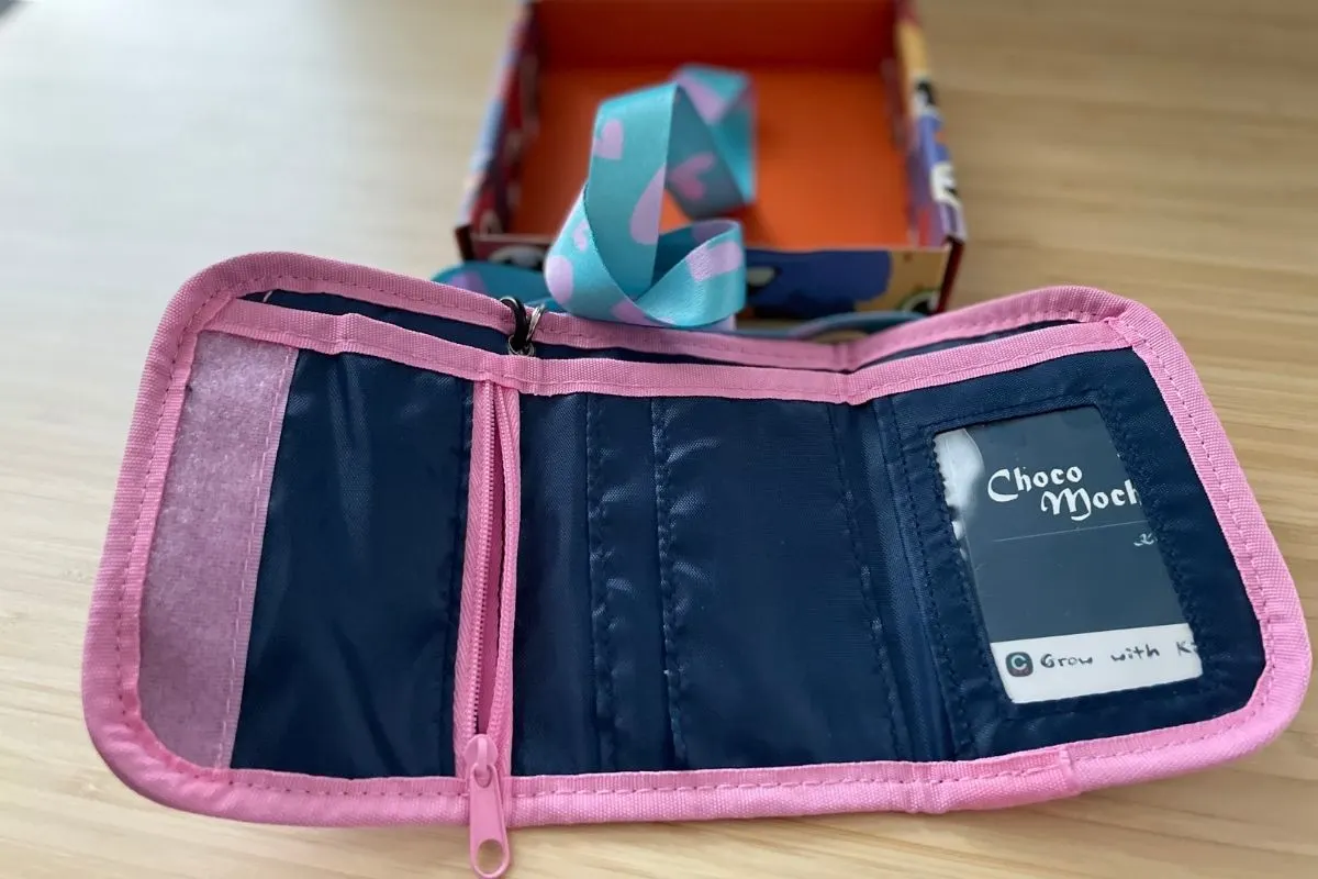 inside of pink bordered and blue wallet with lanyard