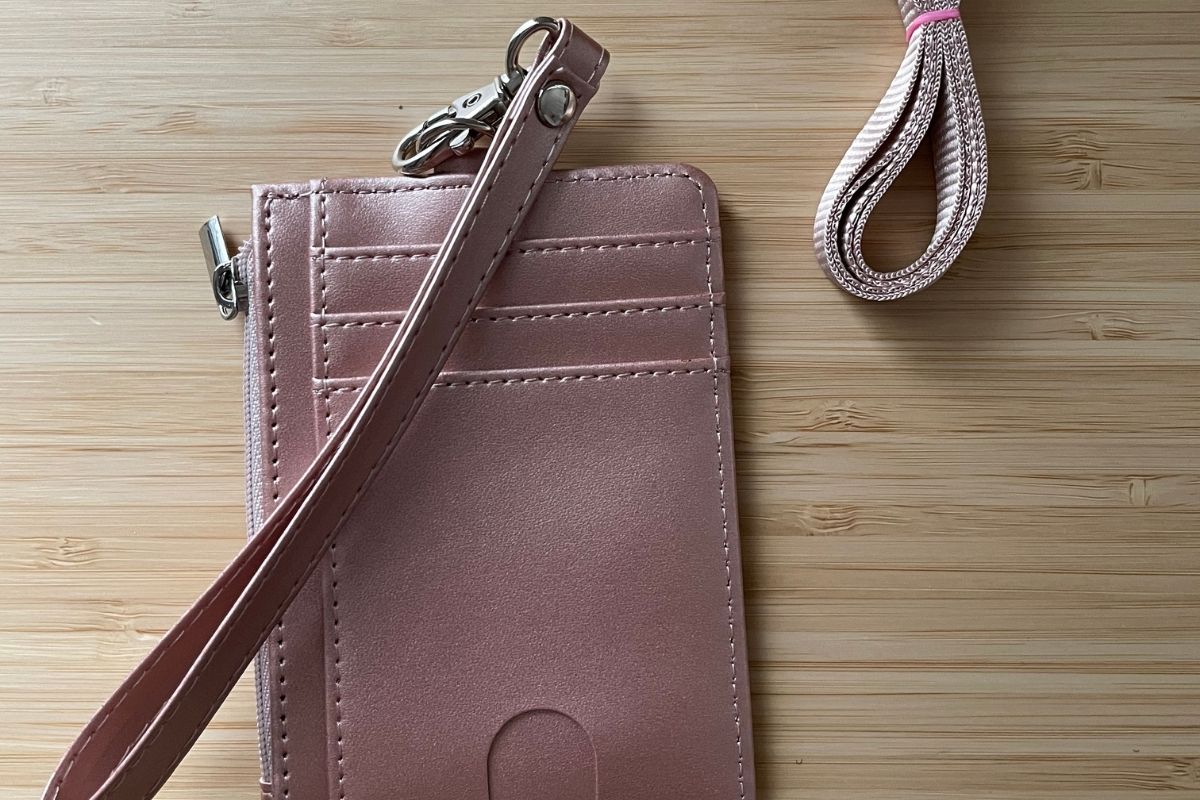 one side of pink sheen wallet with three card slots and lanyard