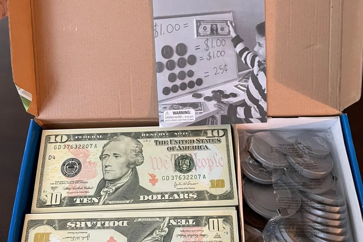 box of giant bills and coins