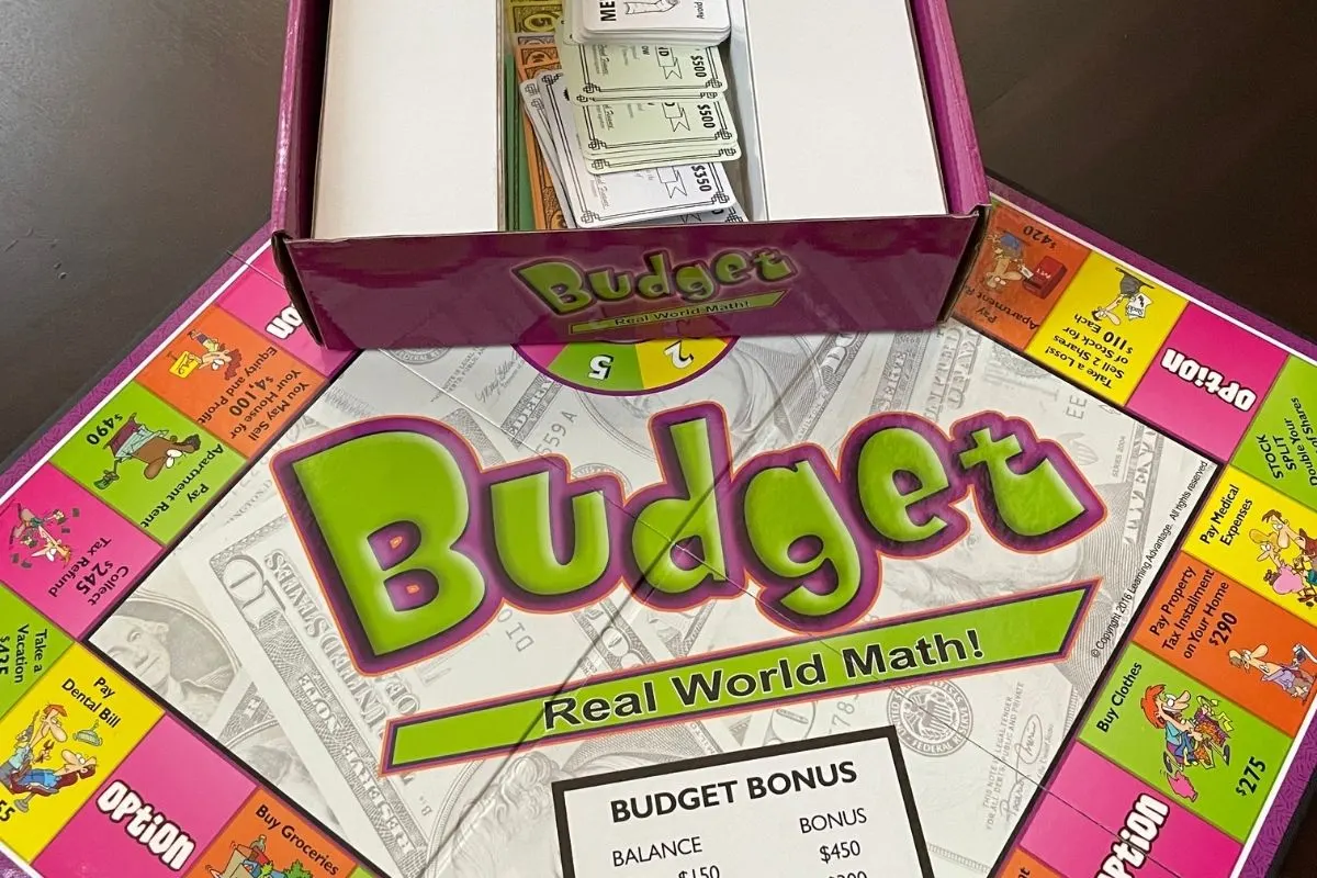 purple and green board game box and game board