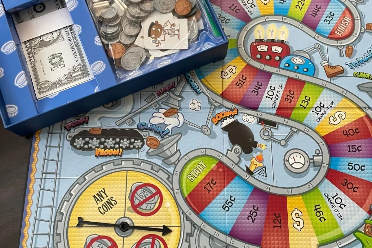 light blue-gray board with spinner and lots of money coin amounts on a big money symbol