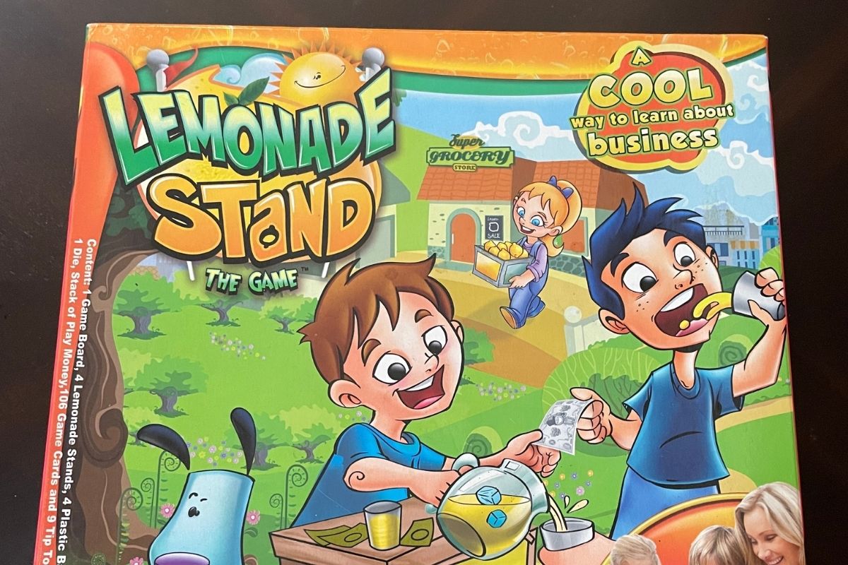 bright orange and yellow game board box with two cartoon kids on lawn selling lemonade