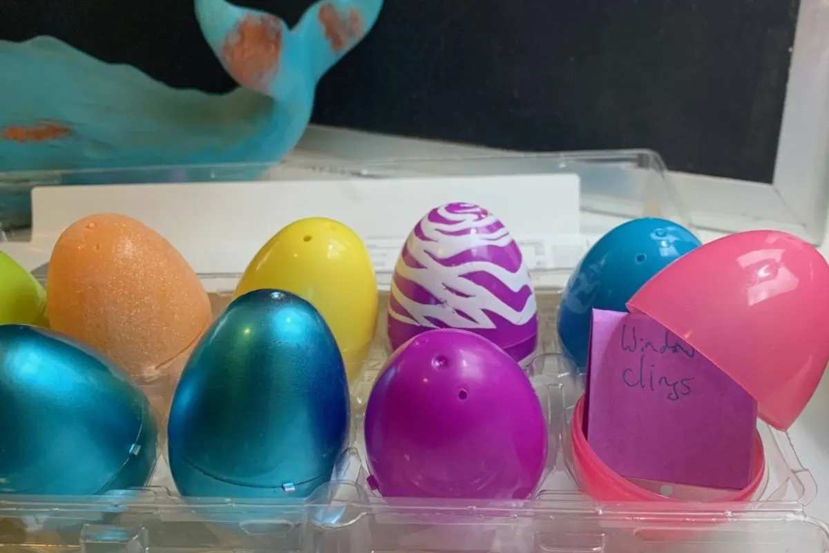 egg carton filled with a dozen Easter eggs, one open with an activity written on a little note
