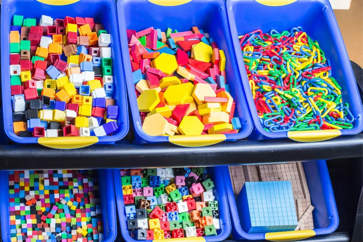 bright purple bins filled with various play sets, organized