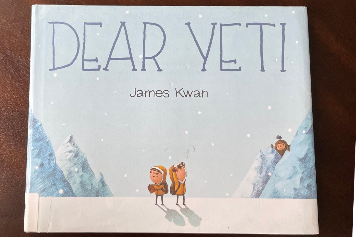 pale blue cover with two kids looking for yeti and yeti hiding behind mountain