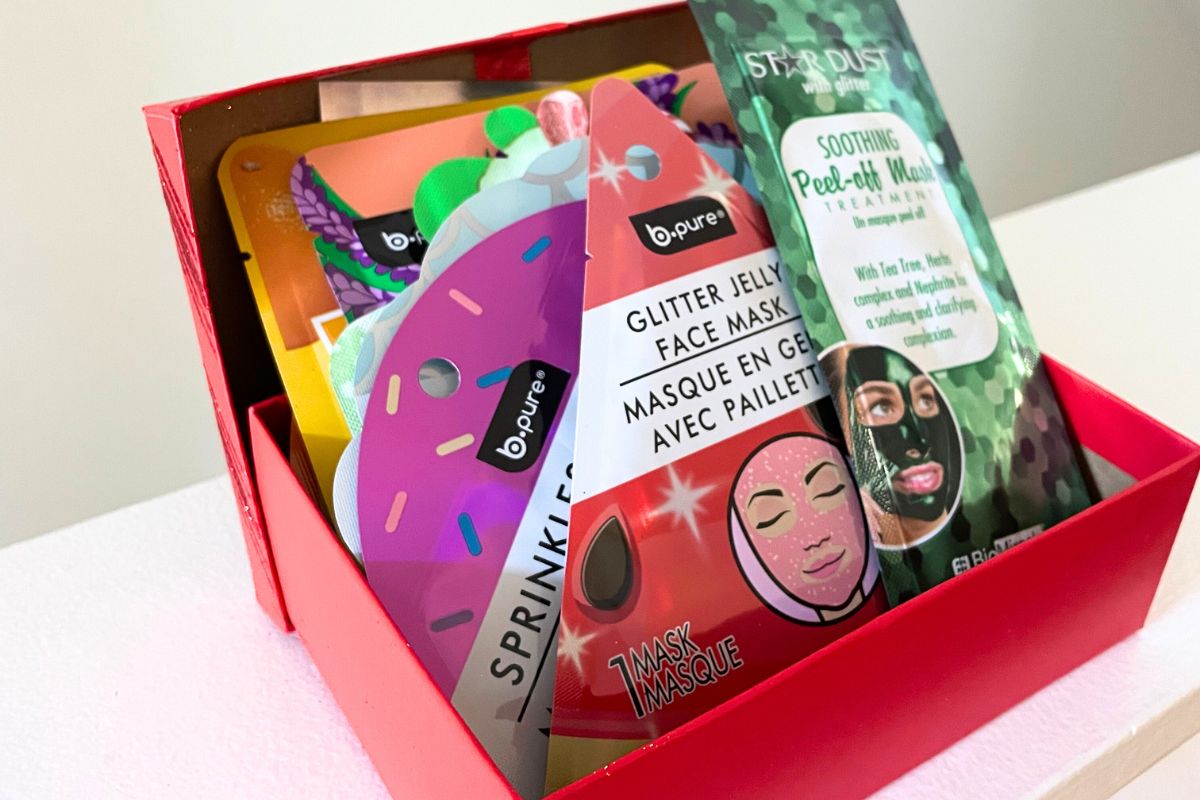 red dollar tree gift box stuffed full of various beauty masks