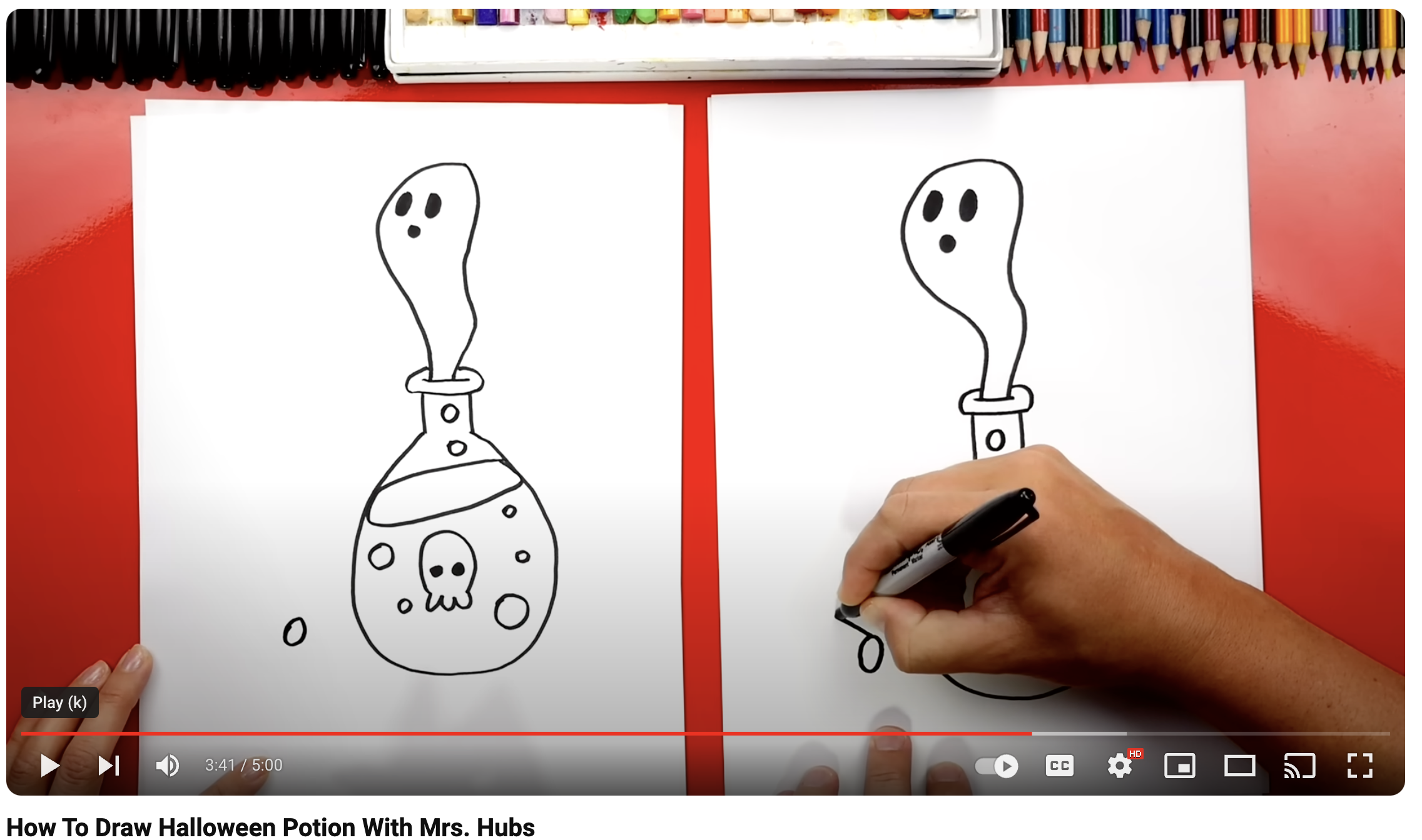 two people working on drawing a ghost coming out of a potion bottle on red background