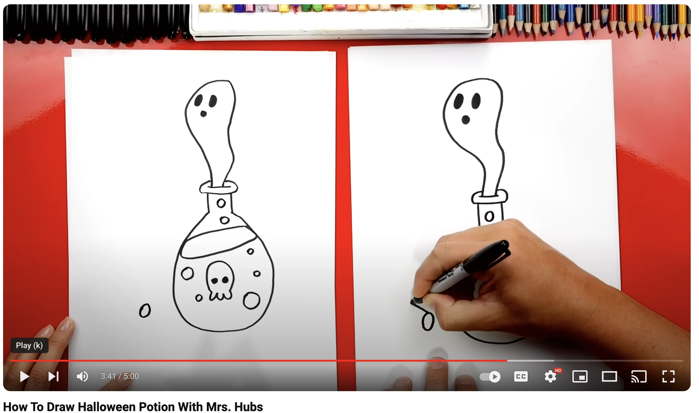 two people working on drawing a ghost coming out of a potion bottle on red background