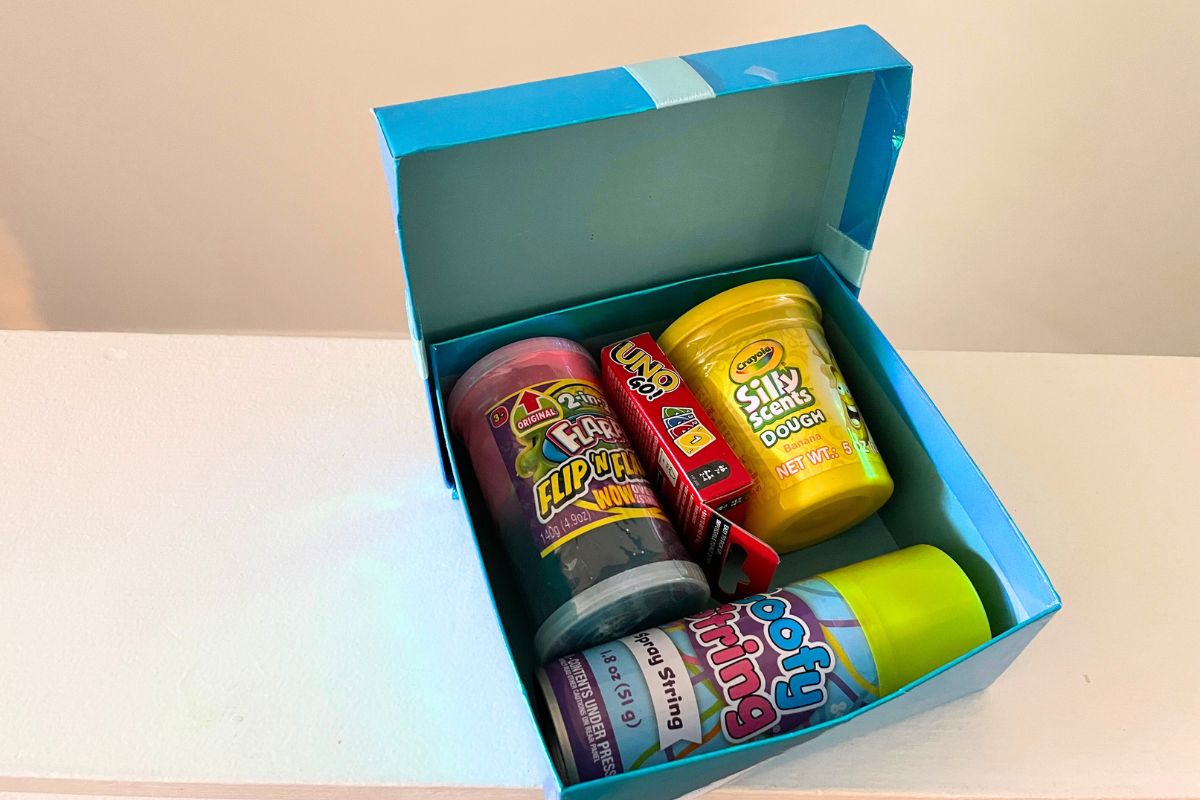 light blue dollar tree box filled with classic toys