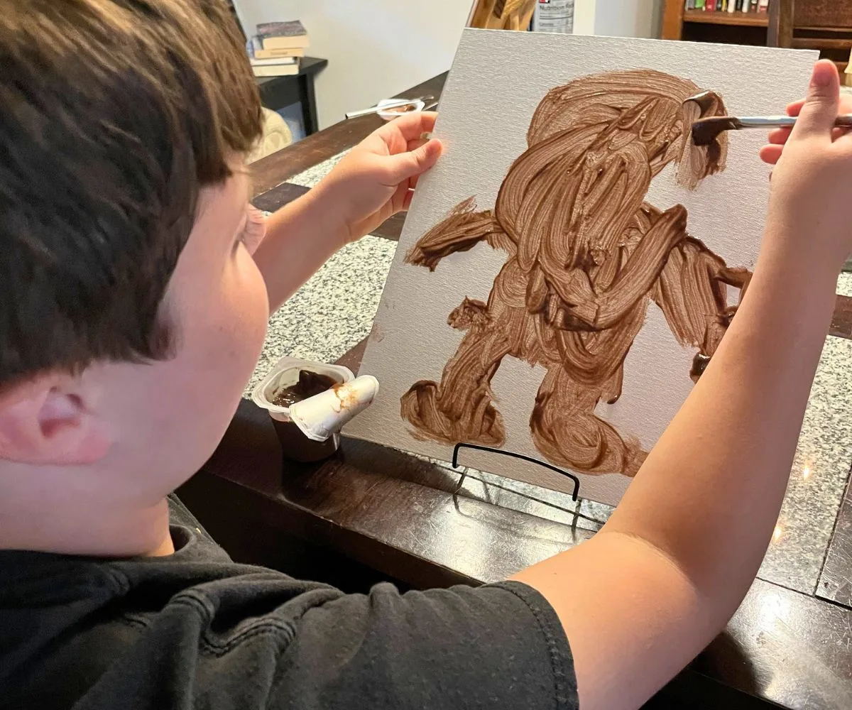 pudding portrait with tween boy painting the last details